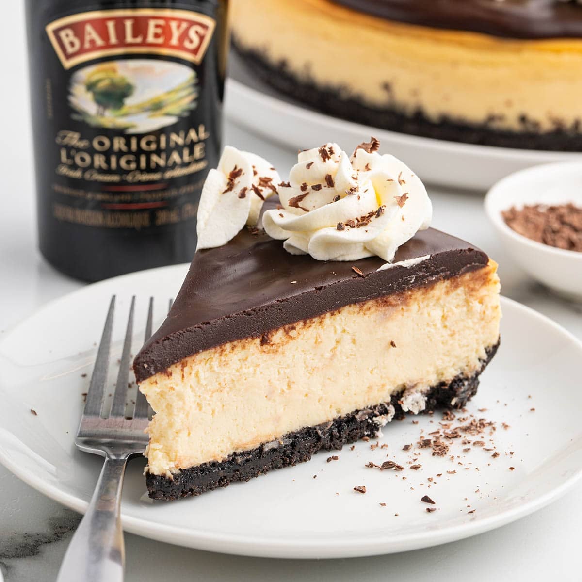 baileys cheesecake slice on a plate.