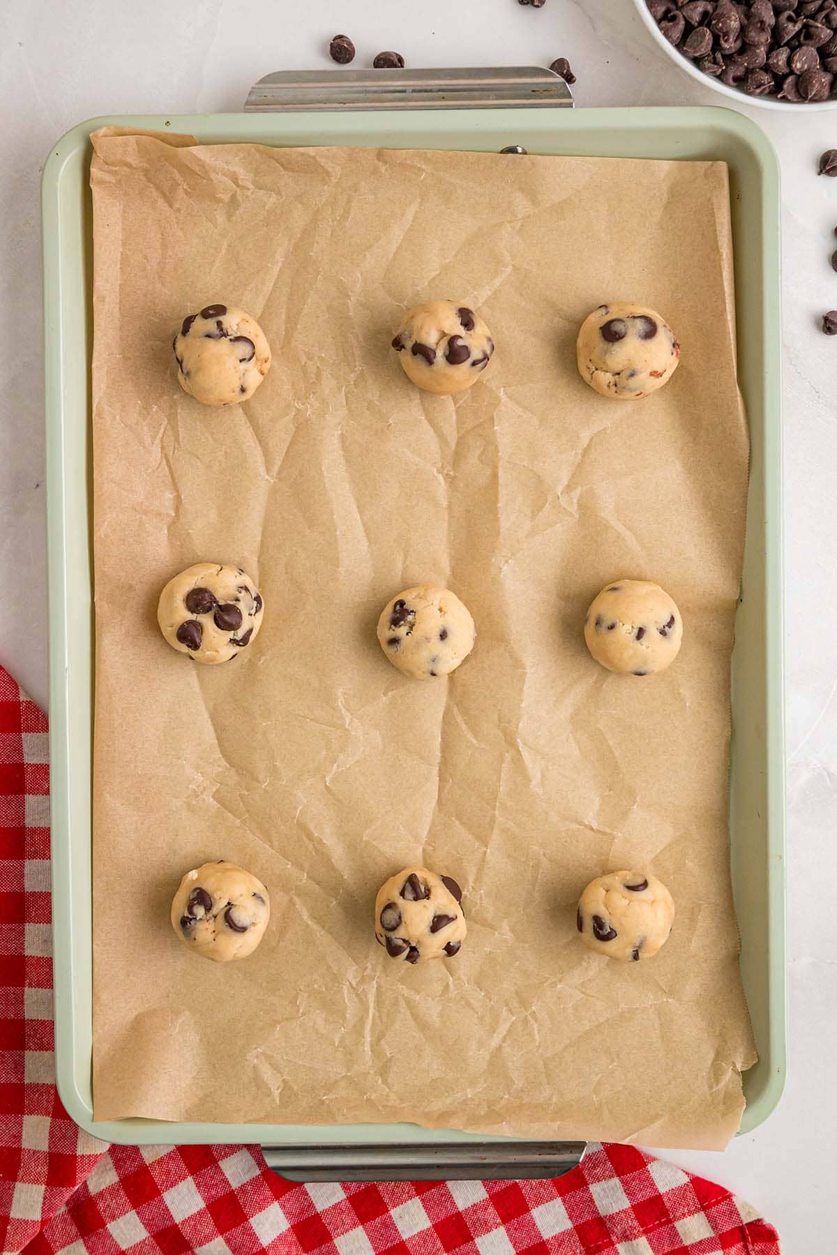 cookie dough balls arranged in baking sheet.