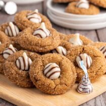gingerbread kiss cookies on wooden board.