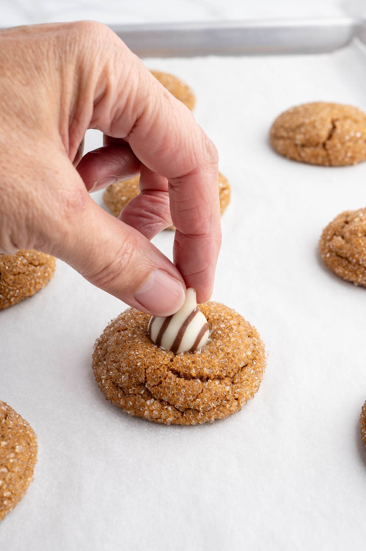 adding kisses into the cookies.