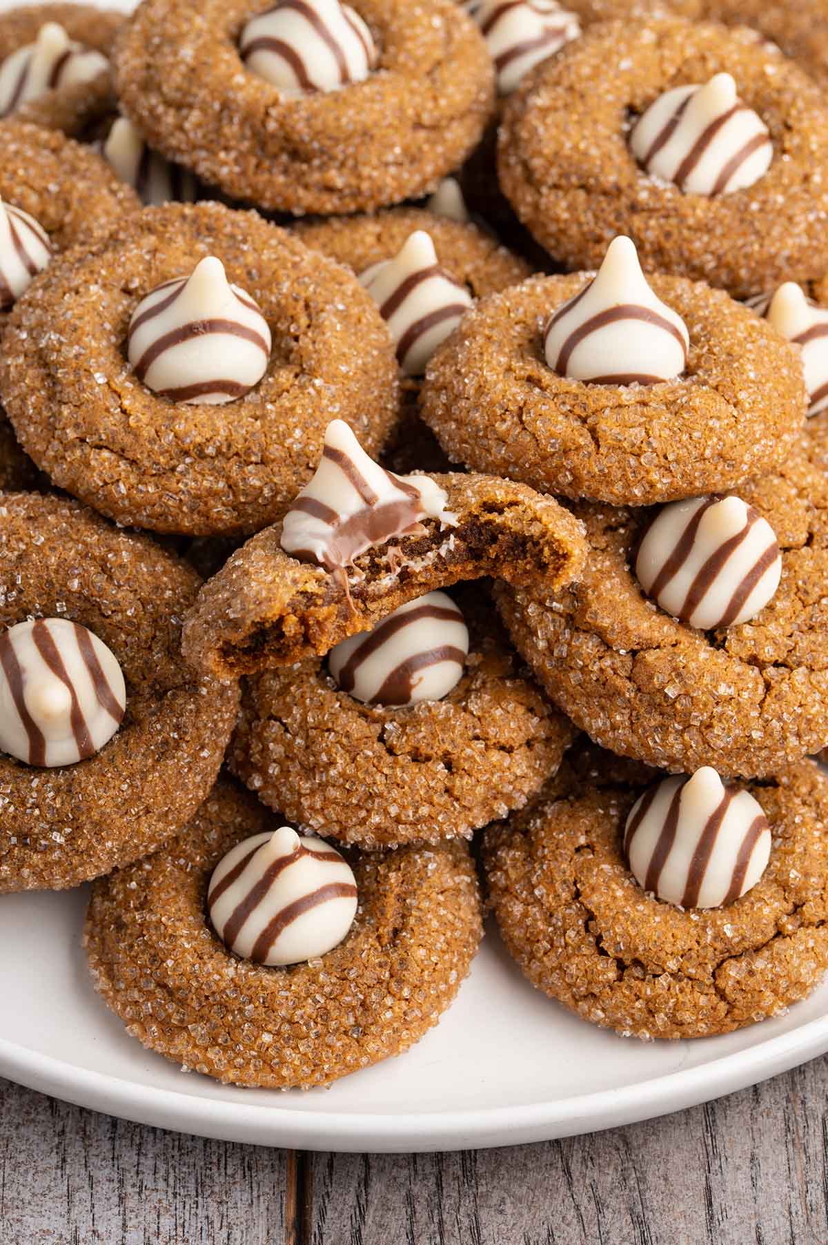 Pile of warm gingerbread treats, each with a creamy white kiss center.