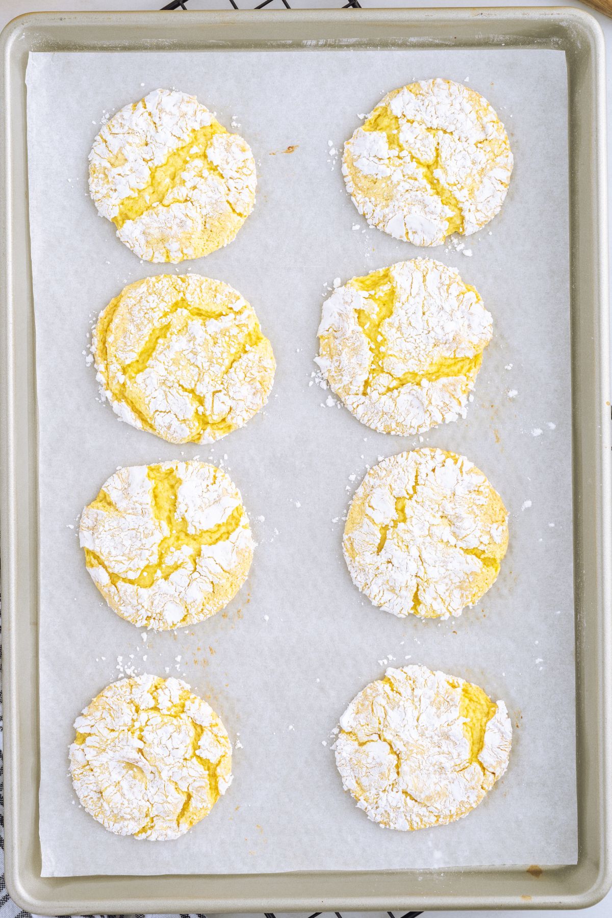 baked lemon cool whip cookies on top of baking sheet.