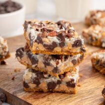 7 layer magic cookie bars on top of wooden table.