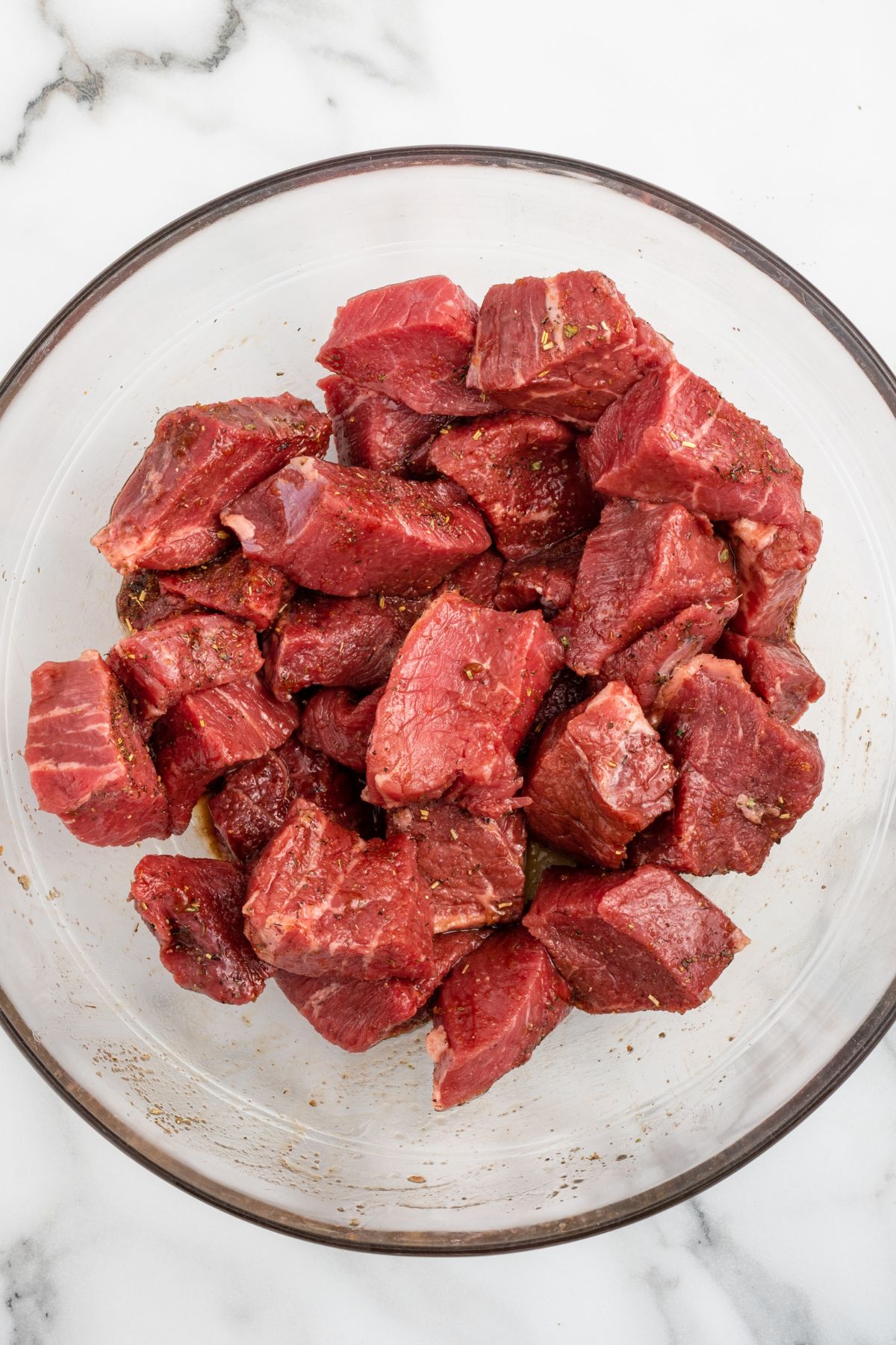 season the steak bites in a bowl.