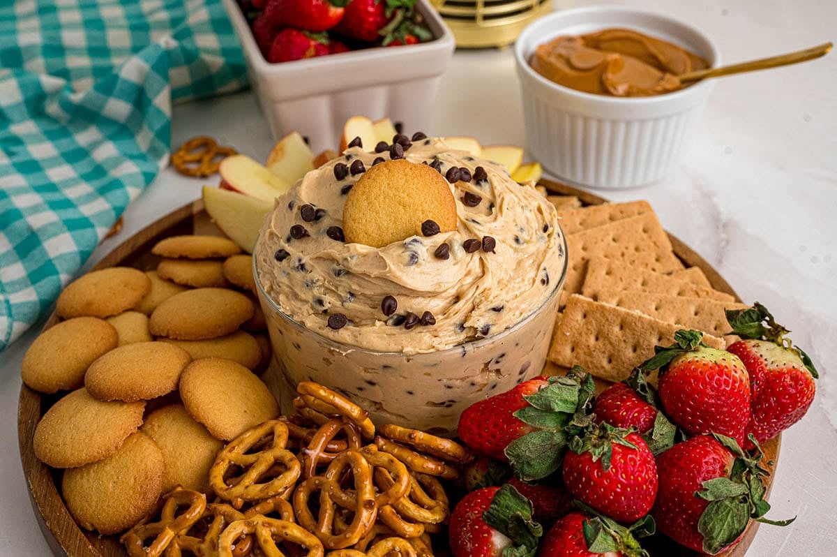 buckeye dip inside a platter with fruits and crackers.