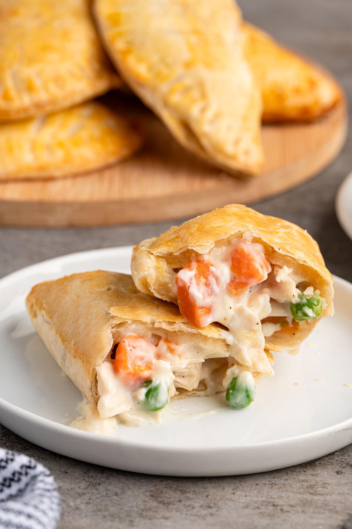 chicken pot pie hand pies splitted into two on a plate.