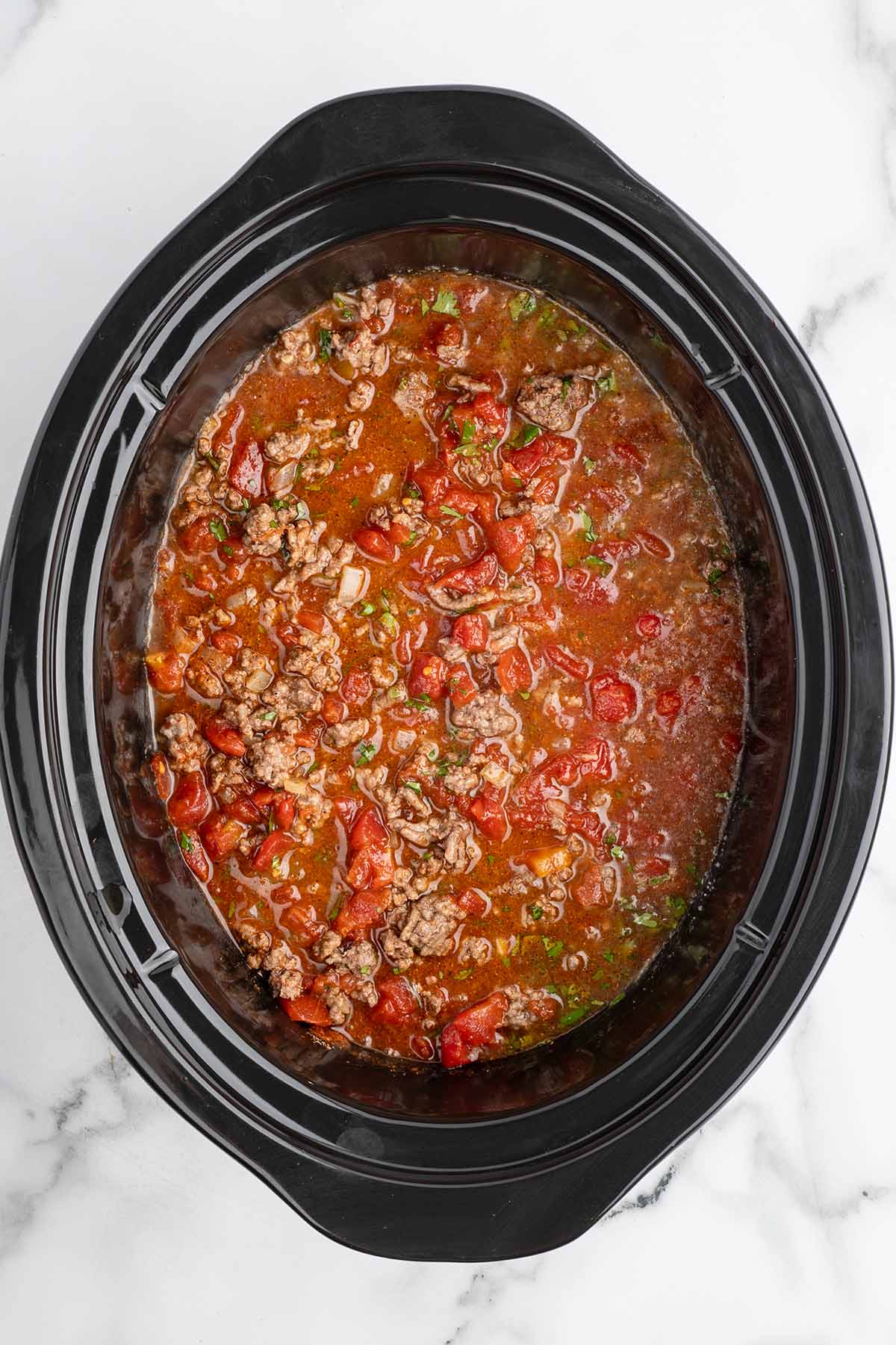 adding all ingredients into the crockpot.