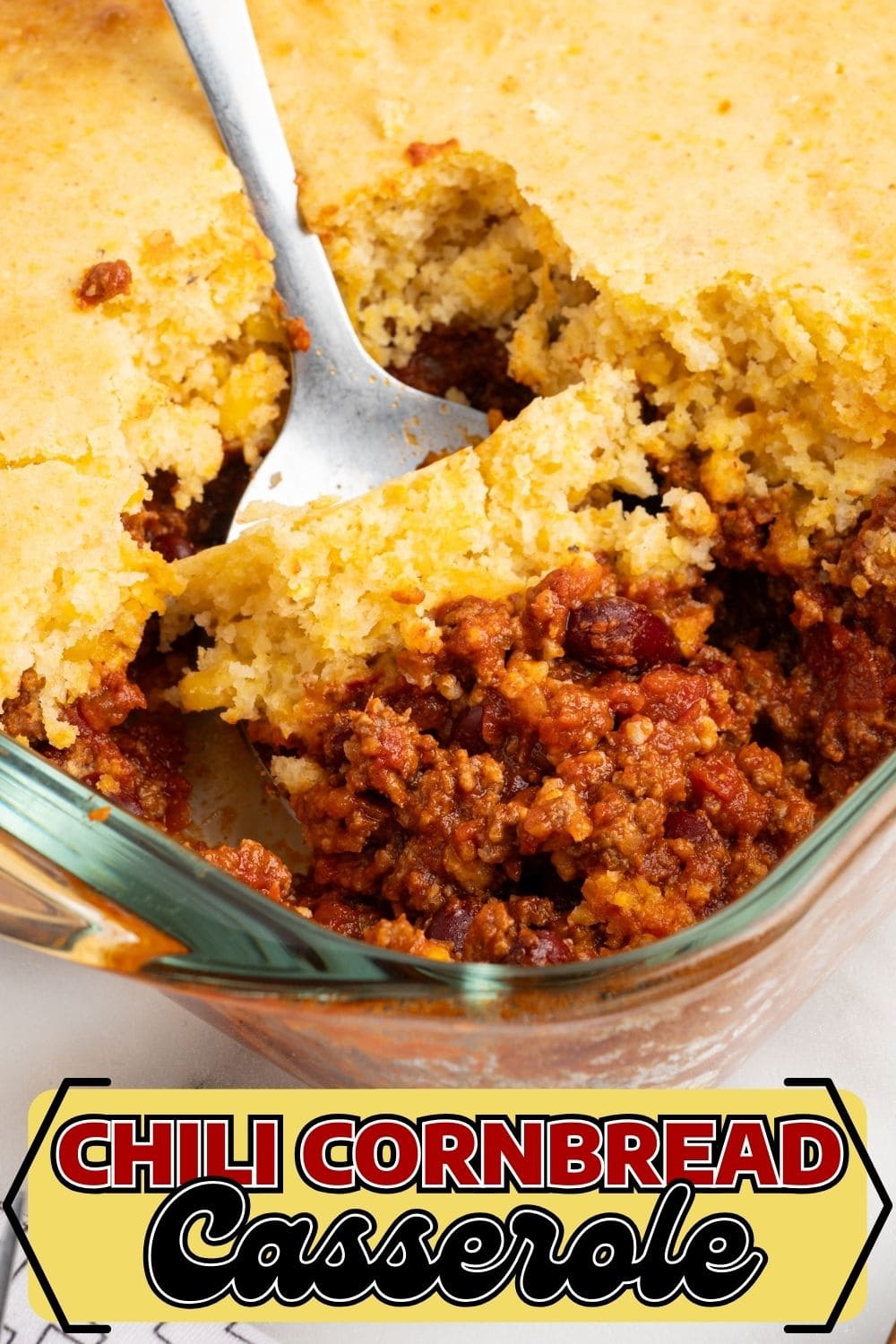 A spoon digging into Chili Cornbread Casserole