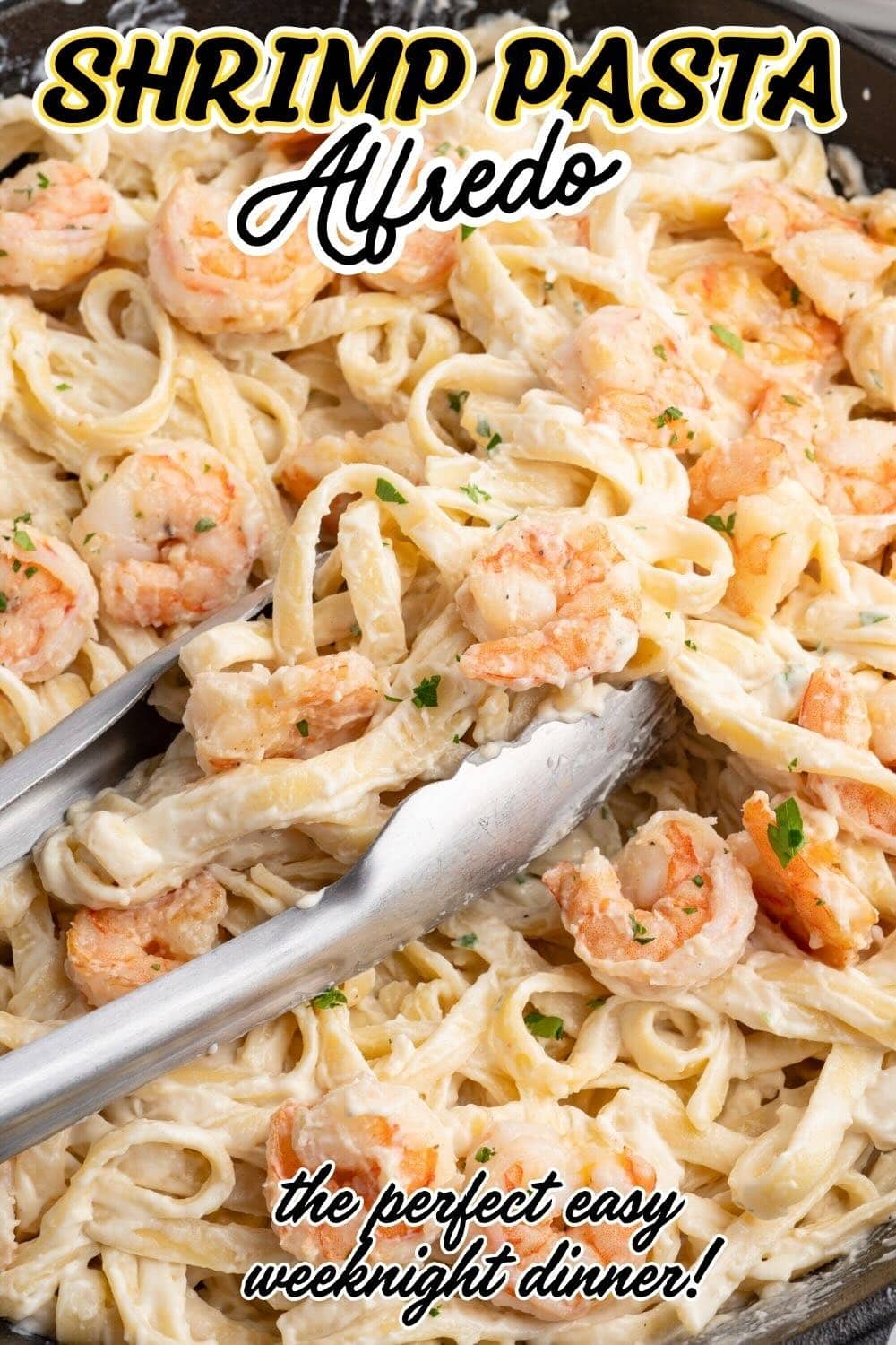 A close-up view of a tong grabbing creamy alfredo pasta with juicy, seared shrimp seasoned with black pepper and garlic.