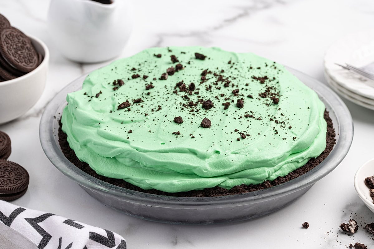 Grasshopper pie with mint green whipped cream topping and Oreo crumbs.