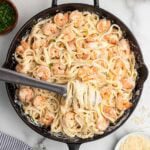 shrimp alfredo pasta in a black skillet