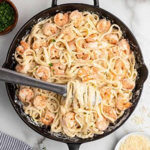 shrimp alfredo pasta in a black skillet