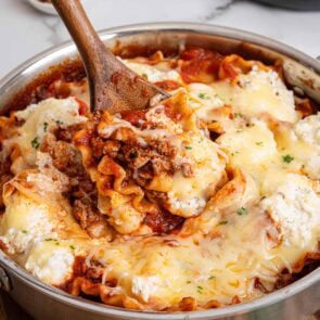 pan with noodles and cheese with a wooden spoon scooping
