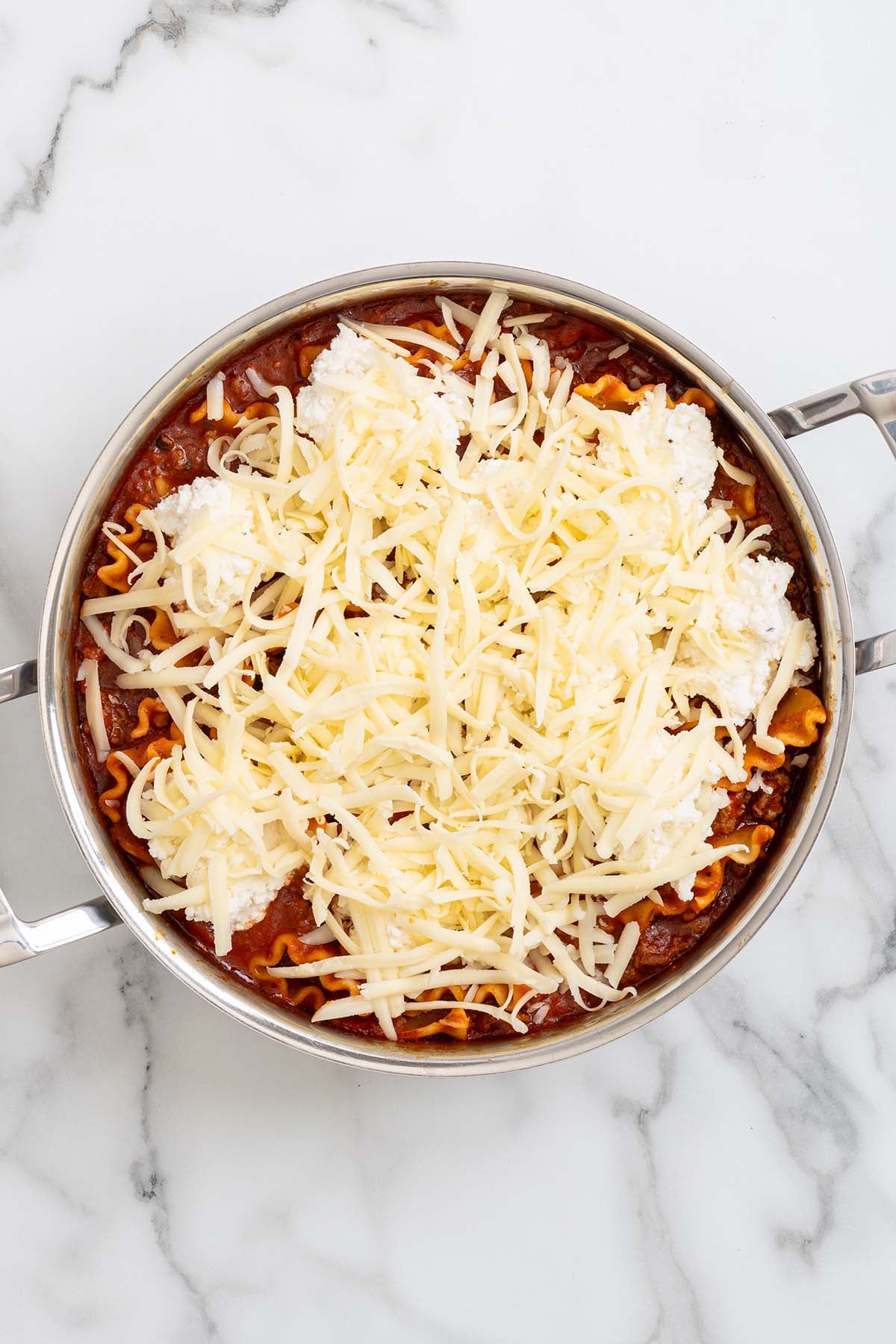 add the ricotta cheese on top of the noodles. 