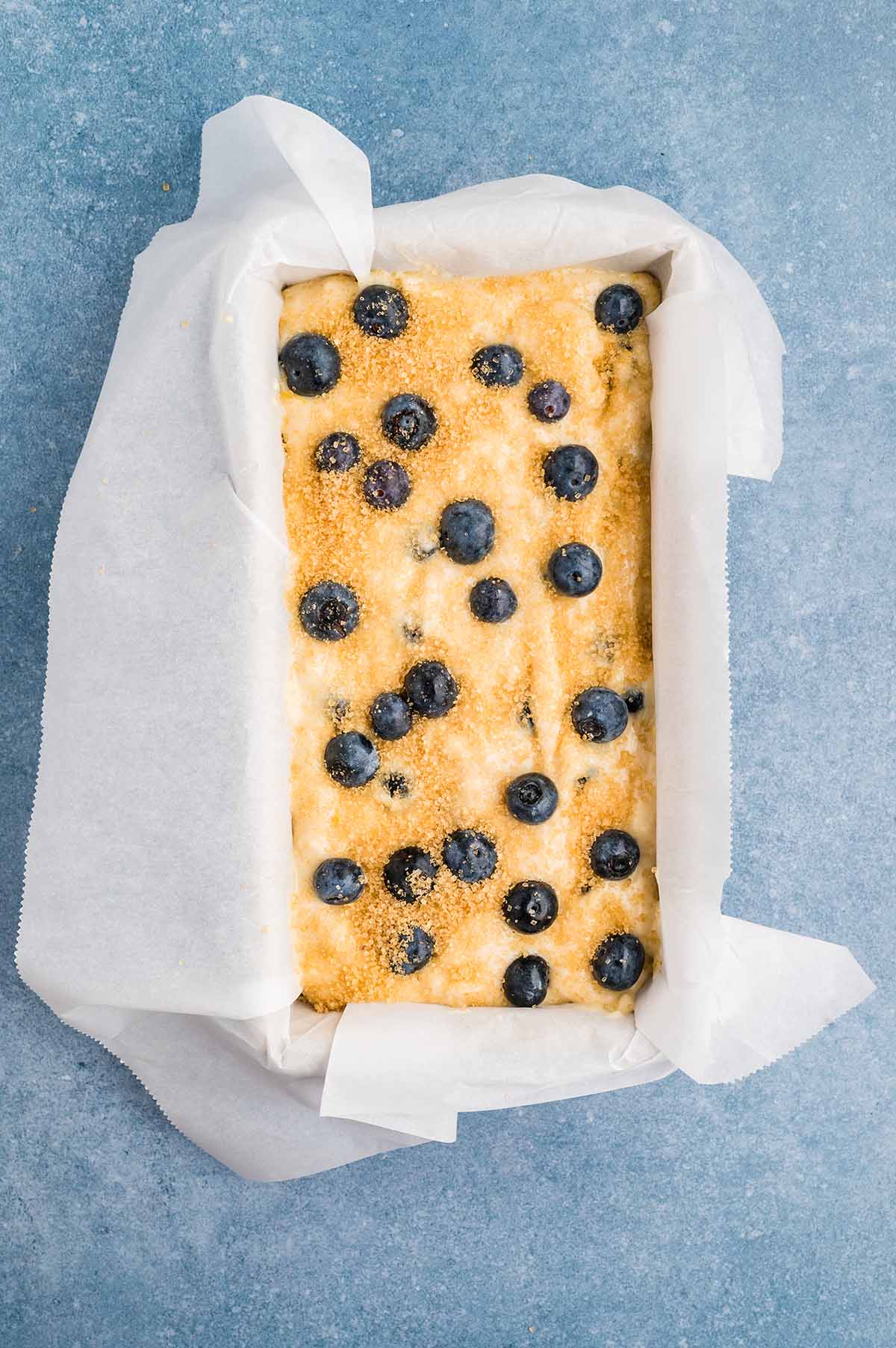 blueberry muffin mixture inside bread loaf pan. 