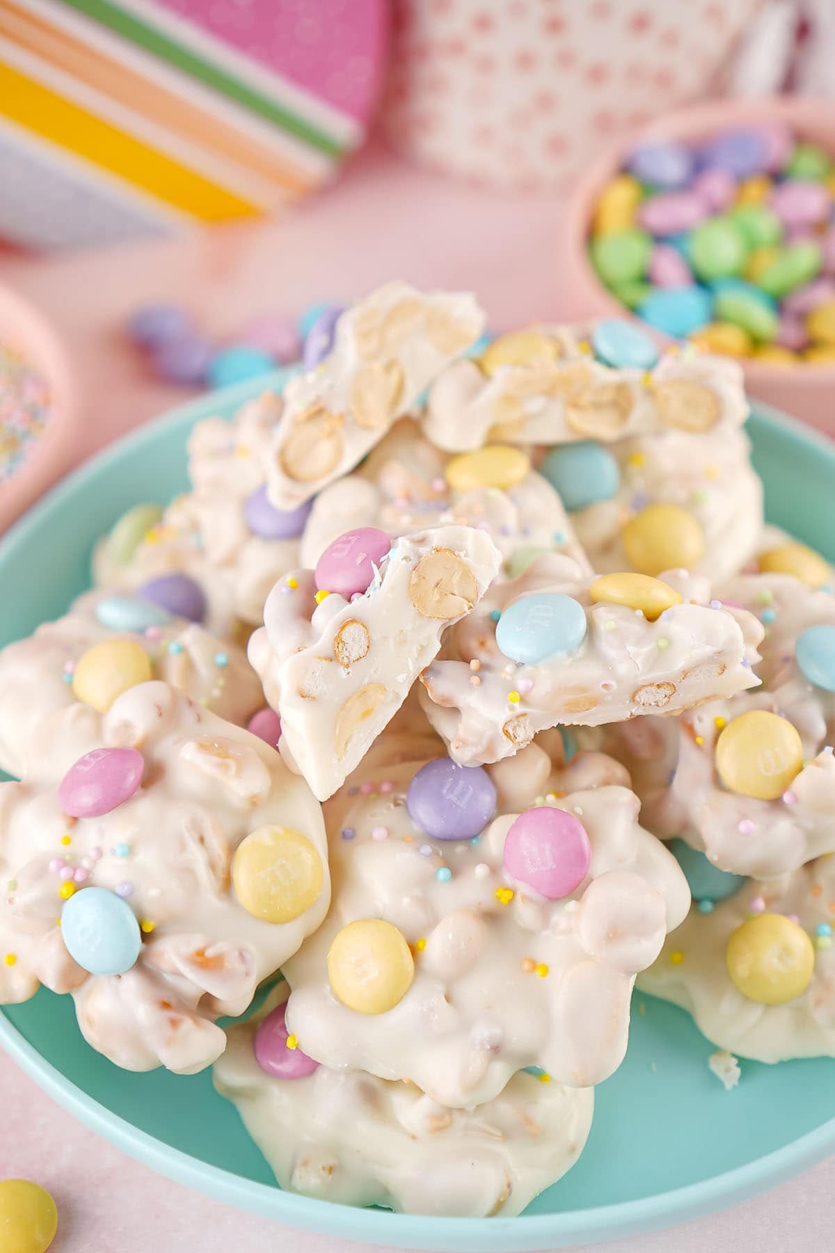 white chocolate crockpot candy stacked on top of pastel blue plate. 