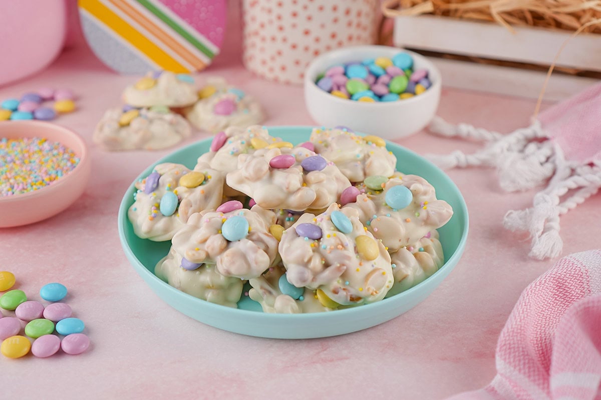 white chocolate crockpot candy on top of blue pastel plate. 