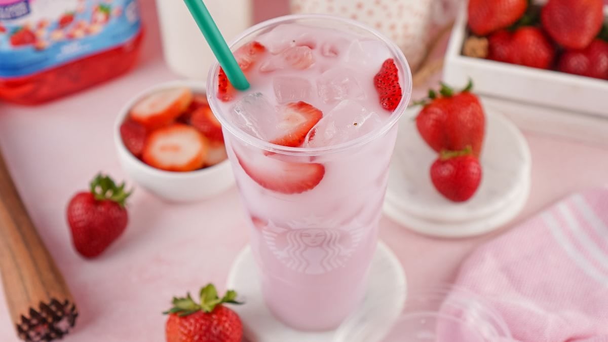 starbucks pink drink with strawberry slices.