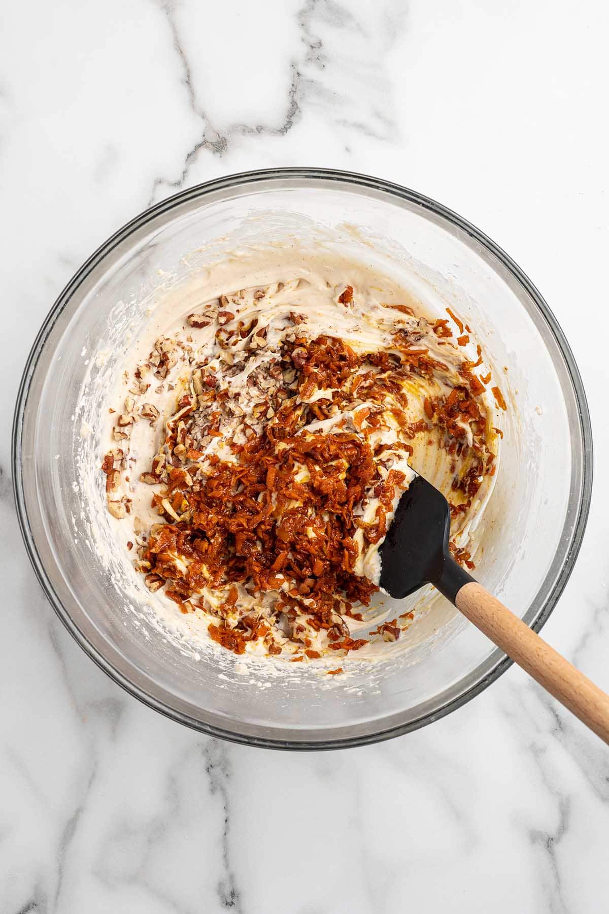 add the carrot and pecans in the bowl. 