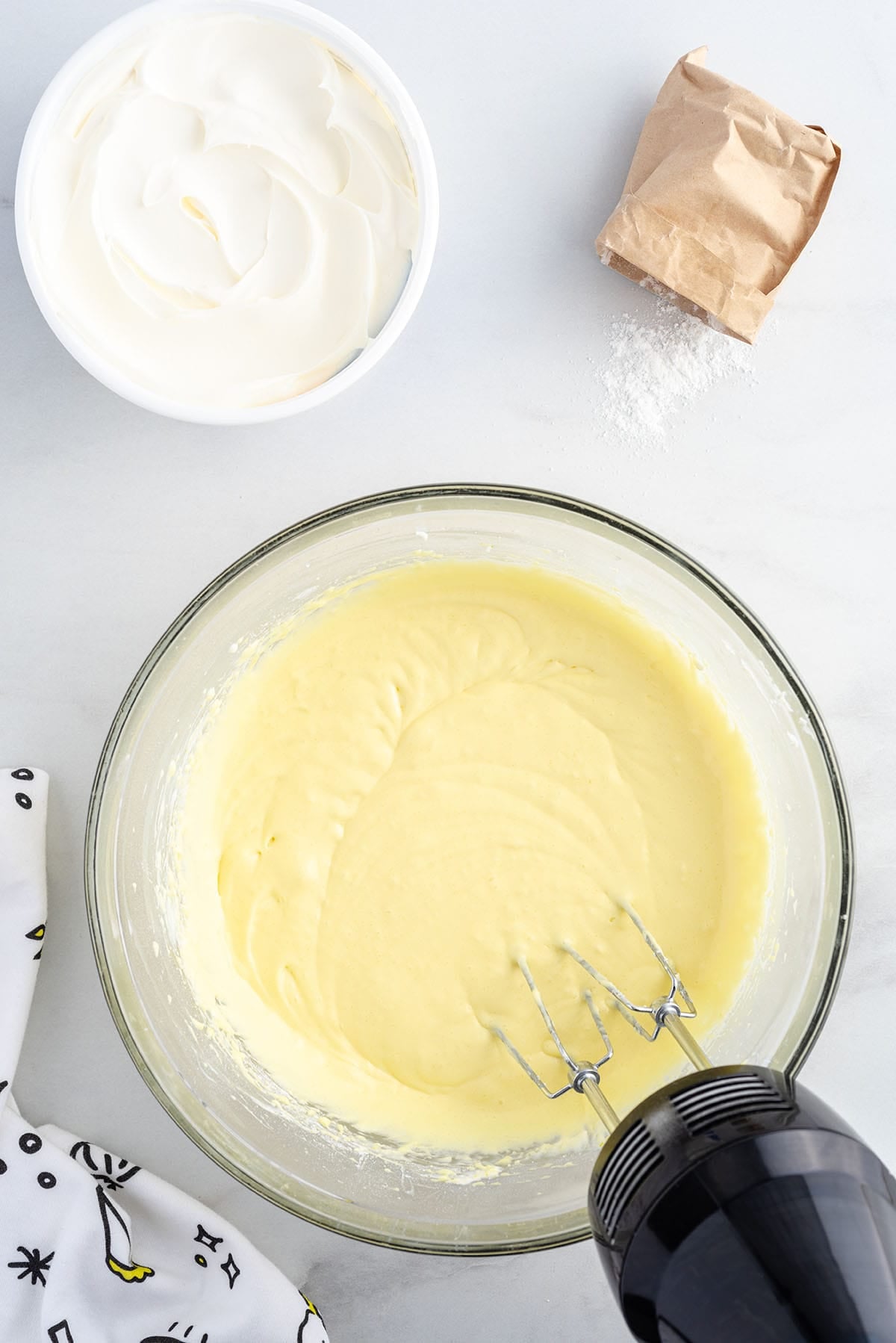 Lower the mixer speed on low and add the instant lemon pudding mix.