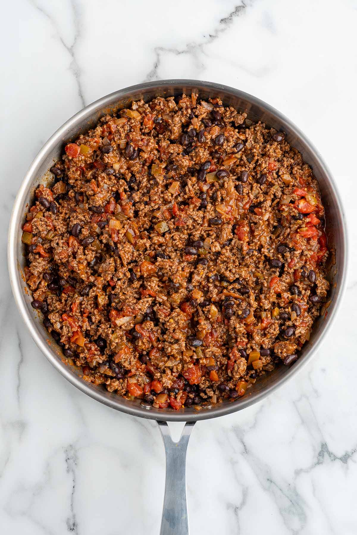 Cooking meat in skillet.