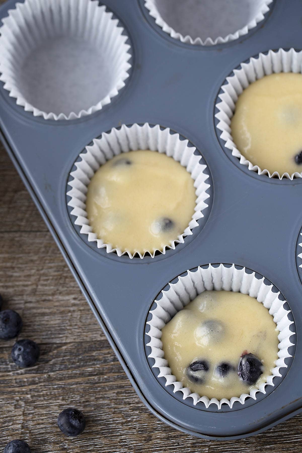 Blueberry muffins batter in the pan. 