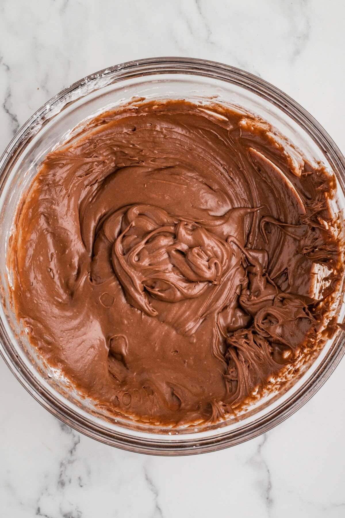 Chocolate frosting in a mixing bowl.