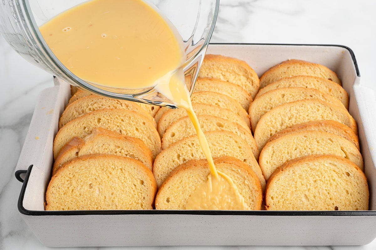 Sliced brioche bread arranged on a wooden cutting board.