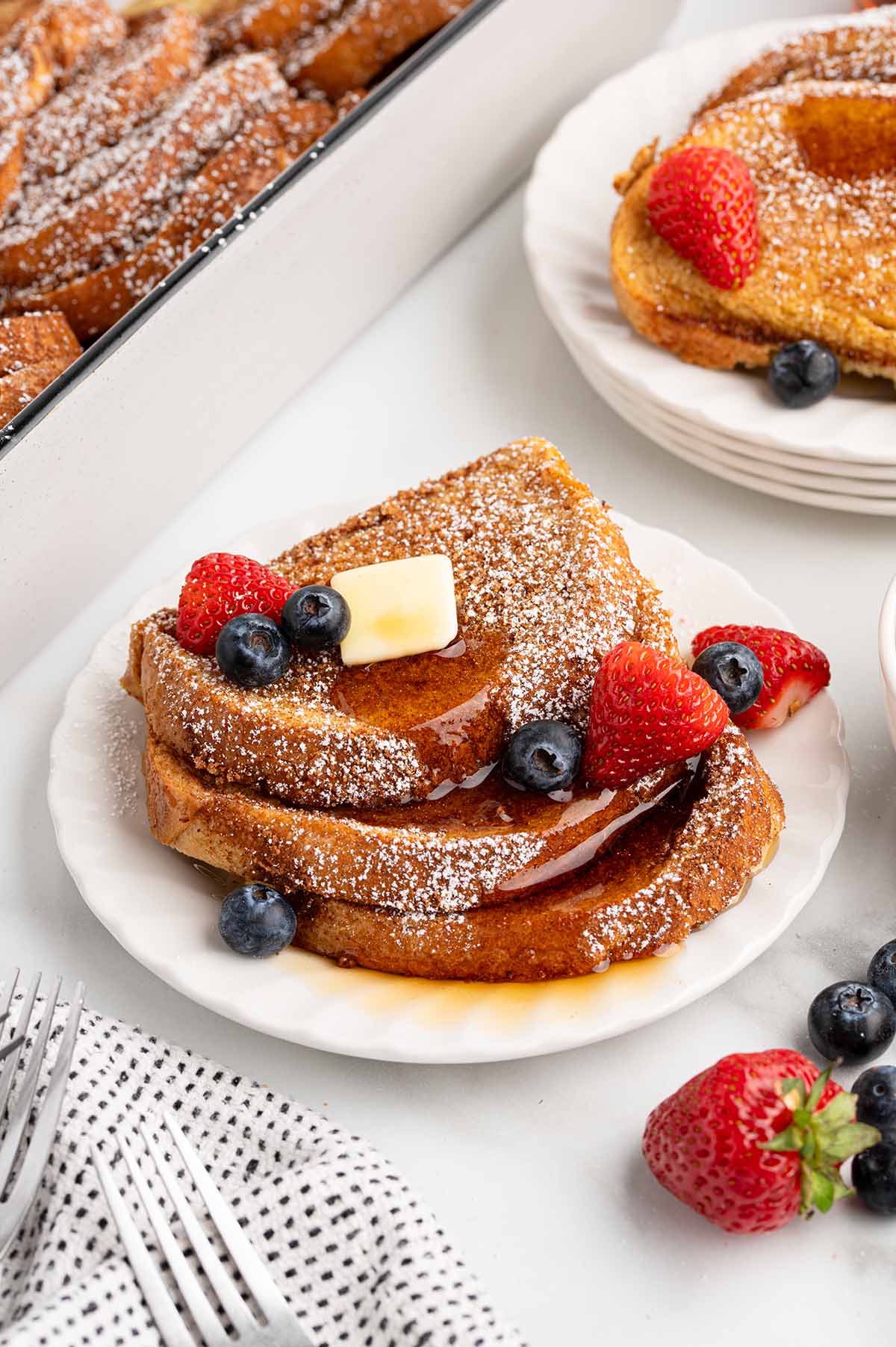 a couple slices of french toast stacked on a plate. 