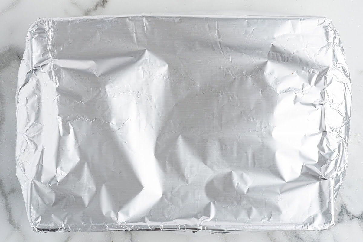 Baking dish covered tightly with aluminum foil.