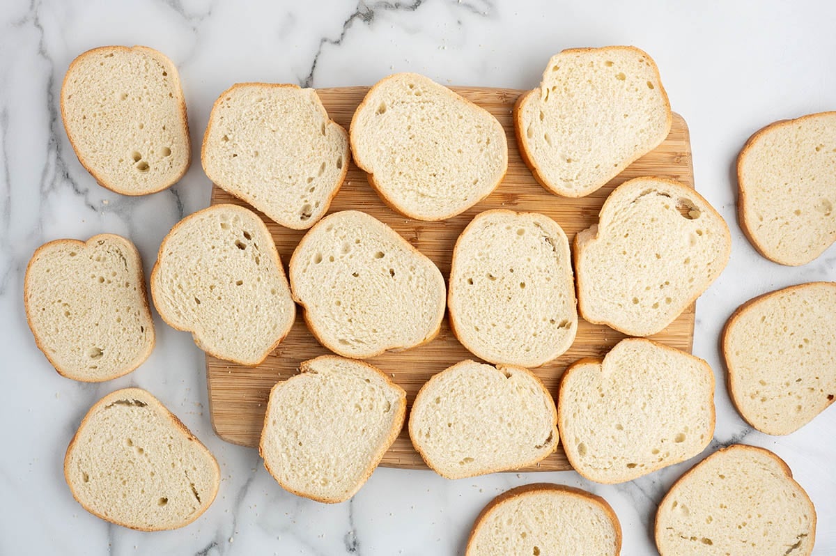 Sliced brioche bread arranged on a wooden cutting board.