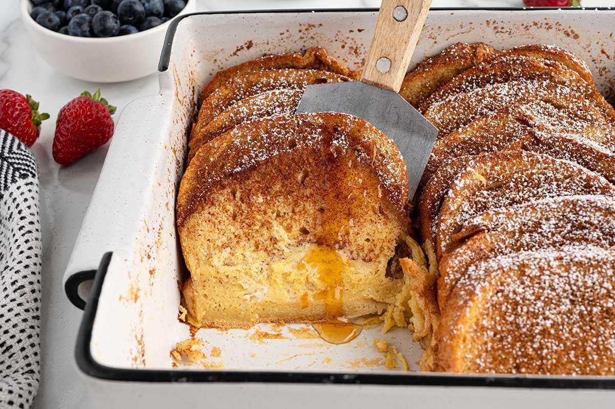 french toast casserole in white casserole dish.