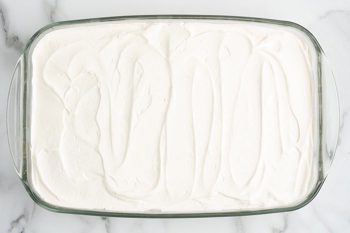 topping the cake with frosting
