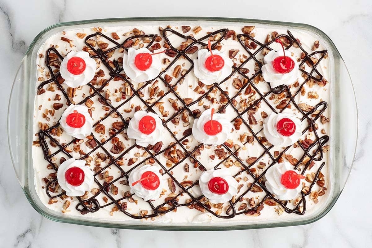 finished top of banana split cake with cherries on top