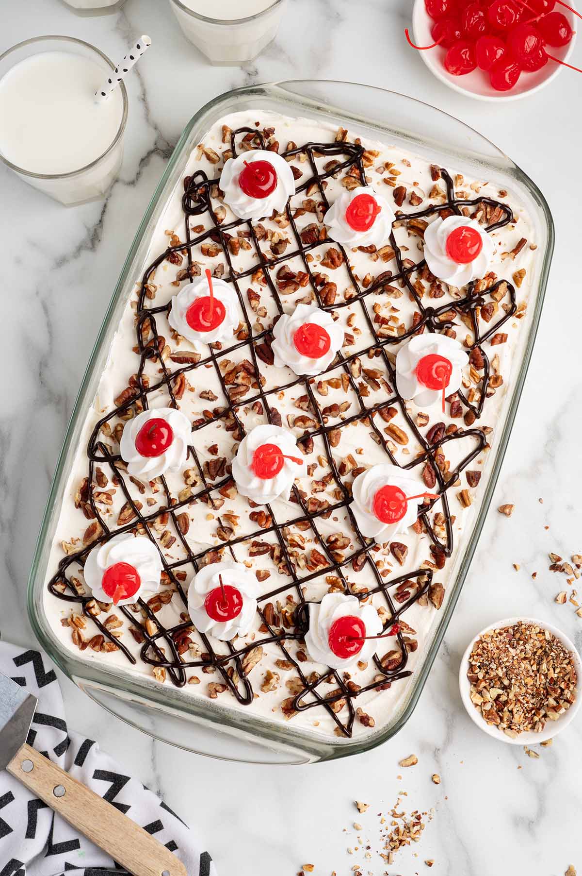 finished top of banana split cake with cherries on top