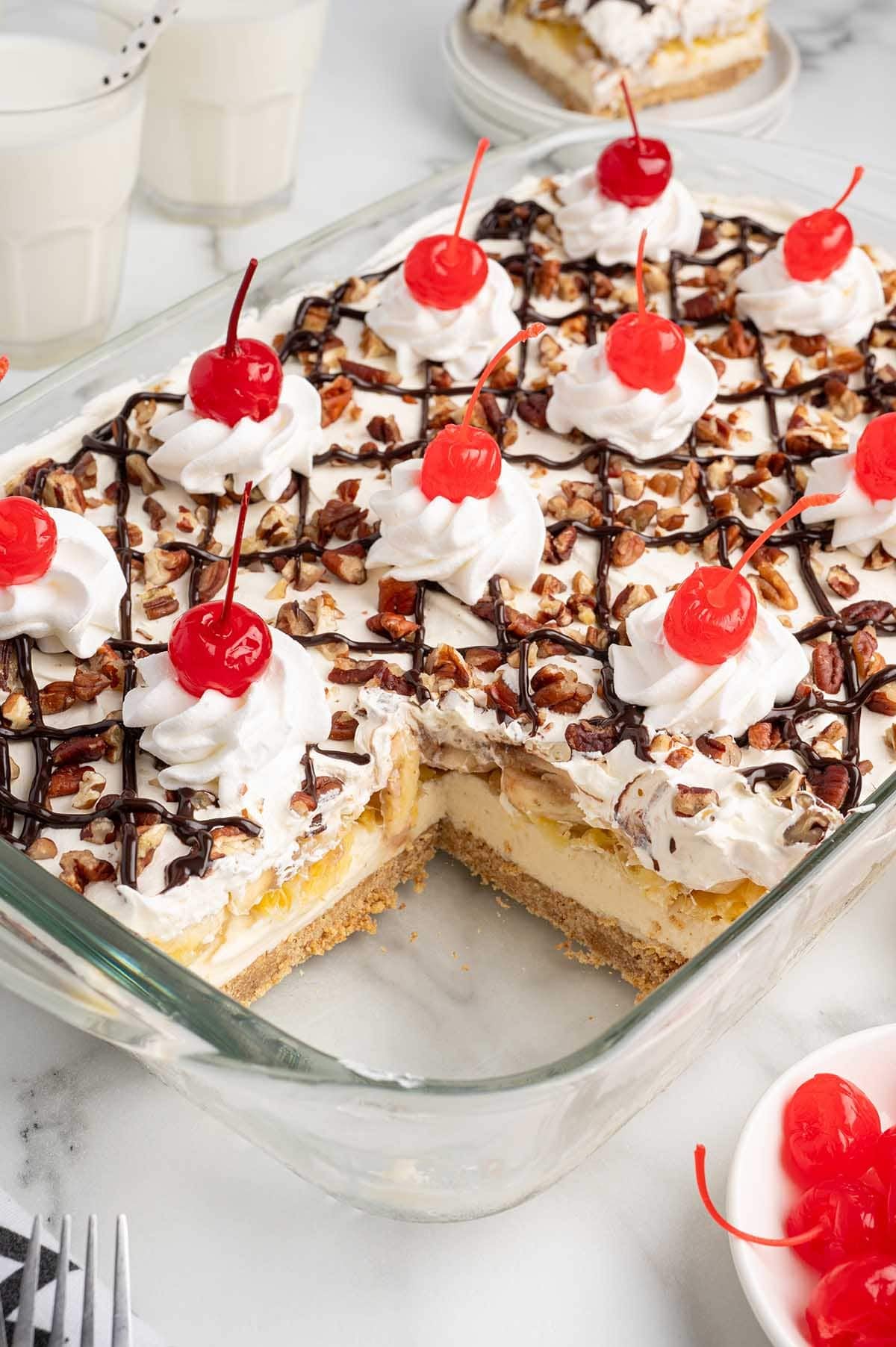 a view from the top of the banana split cake with a slice cut out of the corner