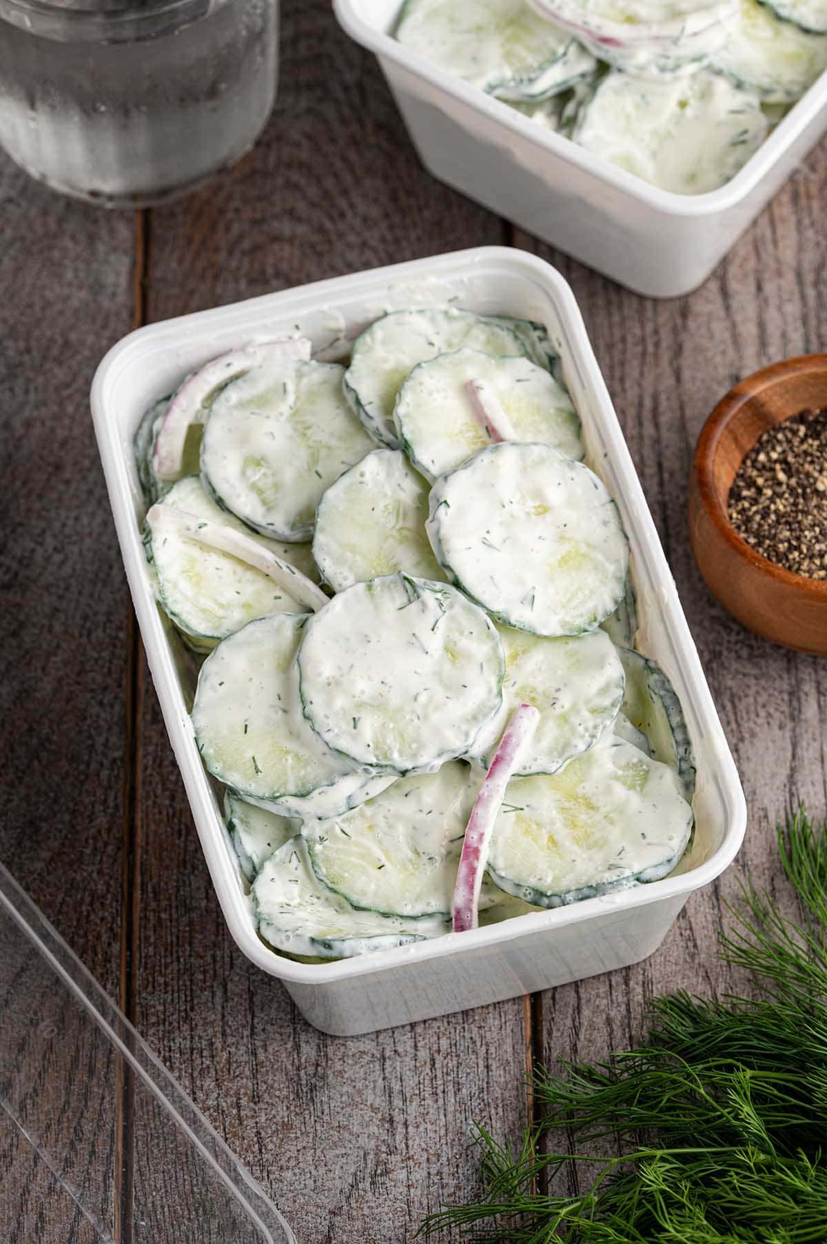 cucumber salad in a rectangle white dish. 