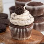 Chocolate cupcake with cookies and cream frosting topped with a mini Oreo.