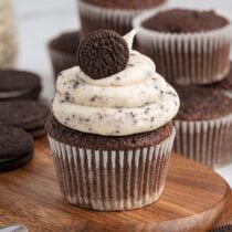 Chocolate cupcake with cookies and cream frosting topped with a mini Oreo.