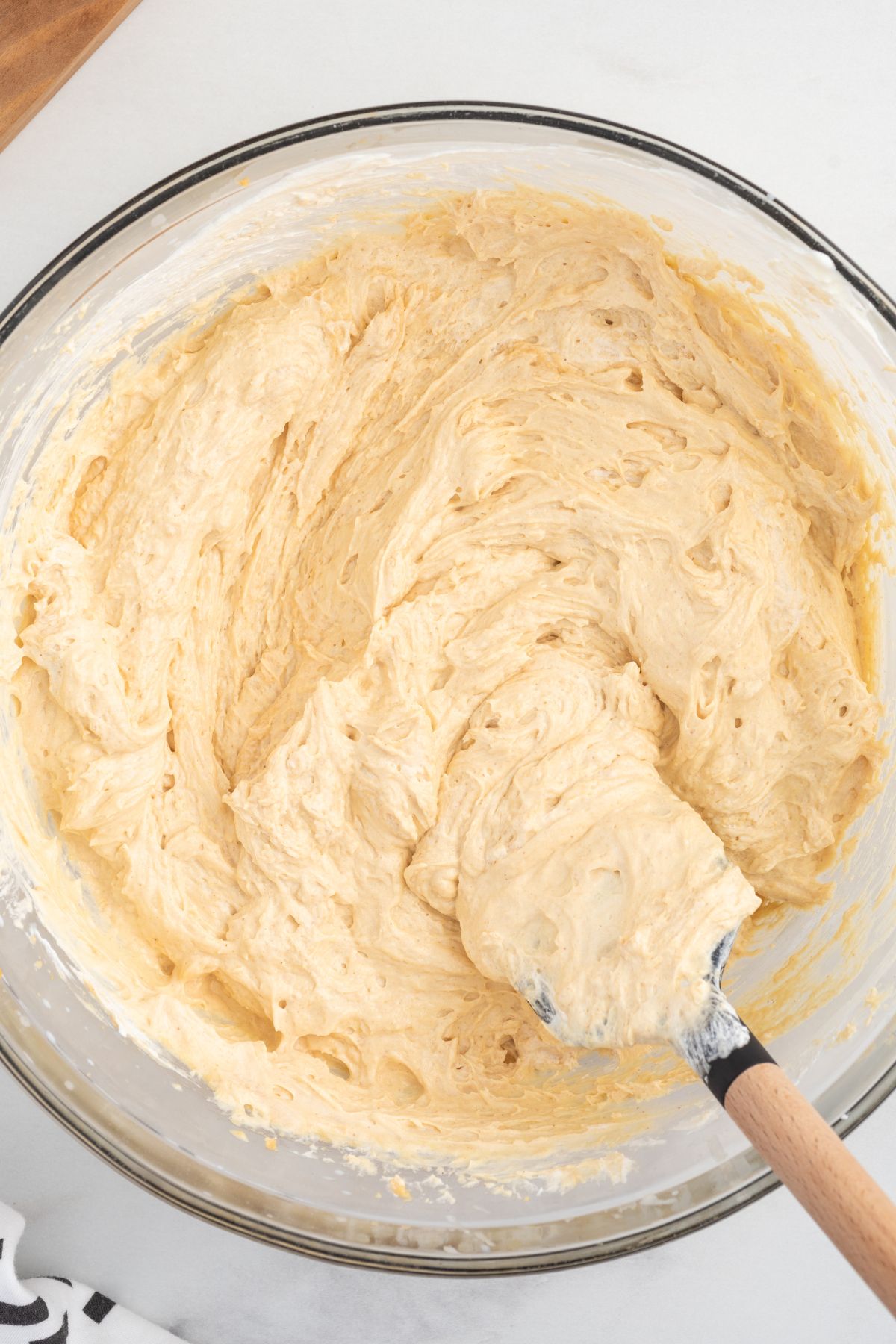 Folding the whipped topping using a rubber spatula.