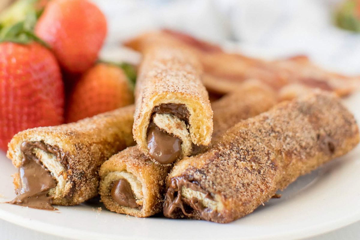Close up Nutella French Toast roll ups on white plate.