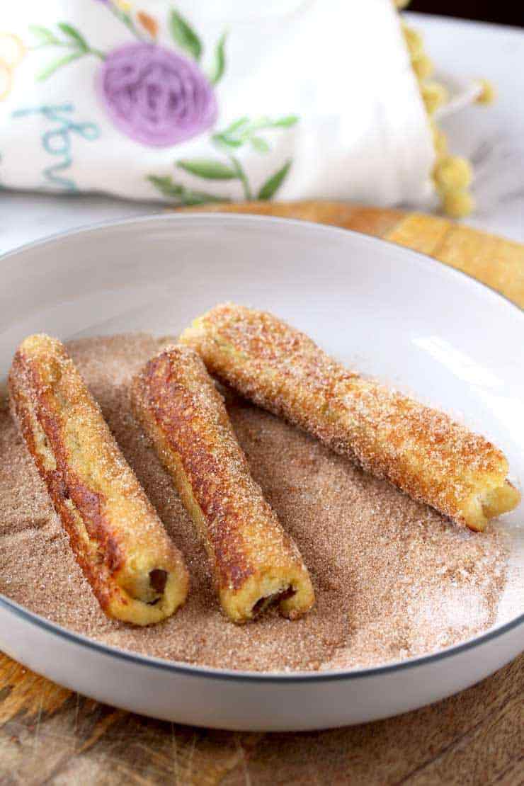 Stir the cinnamon and sugar together in a separate shallow bowl.