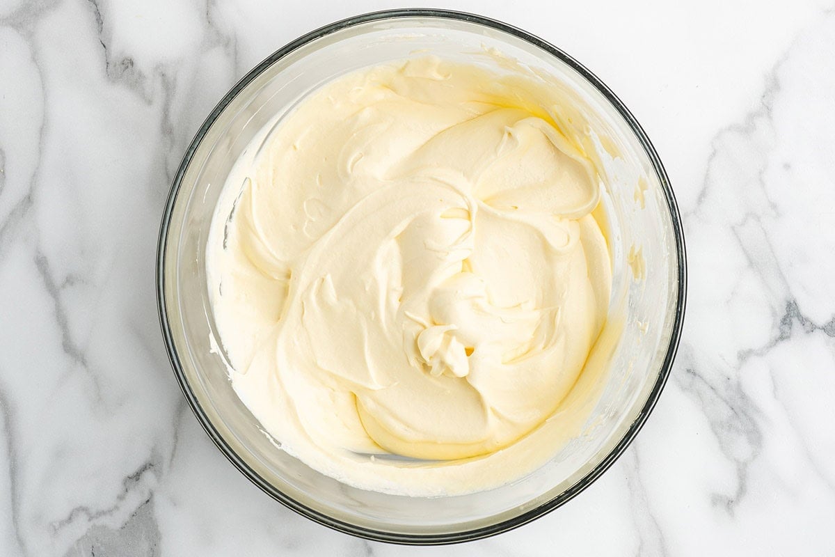 Top-down shot of the creamy vanilla pudding filling mixed until smooth for caramel apple eclair cake.