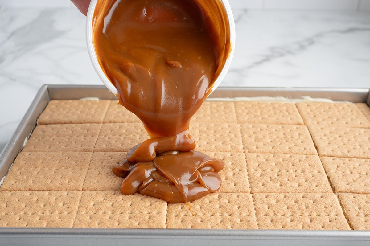 Pour the caramel over the graham cracker layer and spread it into an even layer.