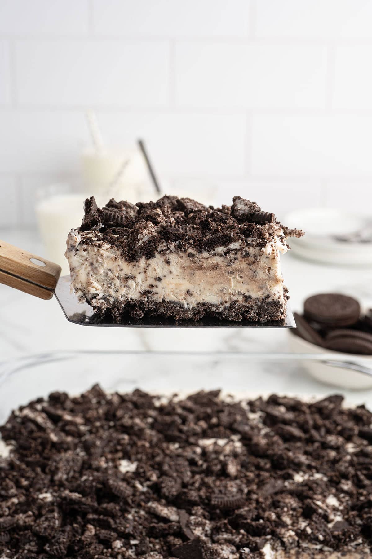 Slice of frozen Oreo dessert lifted on a spatula.