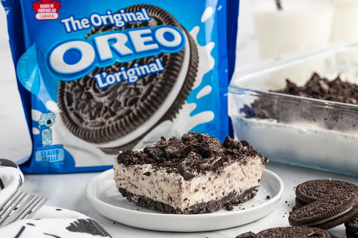 Slice of frozen Oreo dessert topped with crushed cookies.