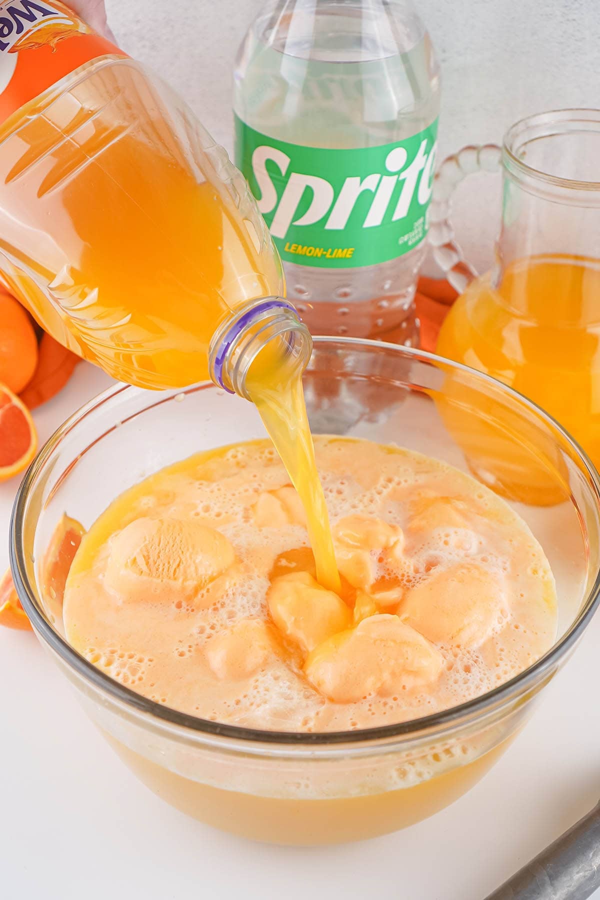 Orange soda float punch with Sprite and vanilla ice cream in a glass bowl.