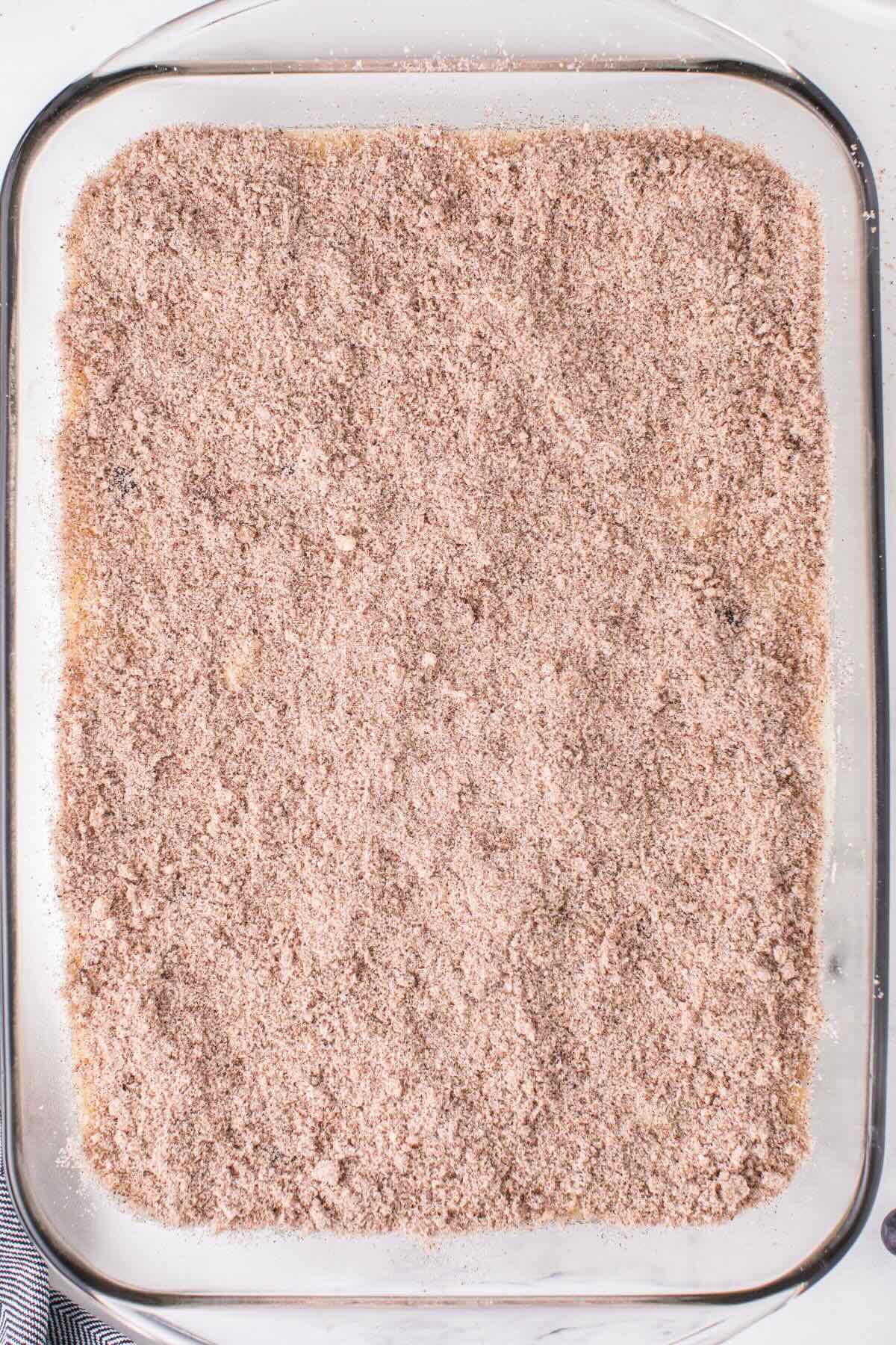 top the blueberry cake with streusel mixture. 