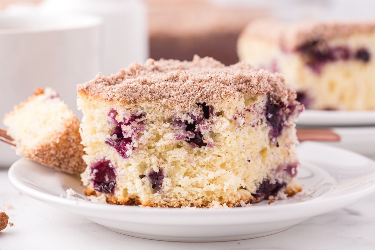 a slice of blueberry breakfast cake on a plate. 
