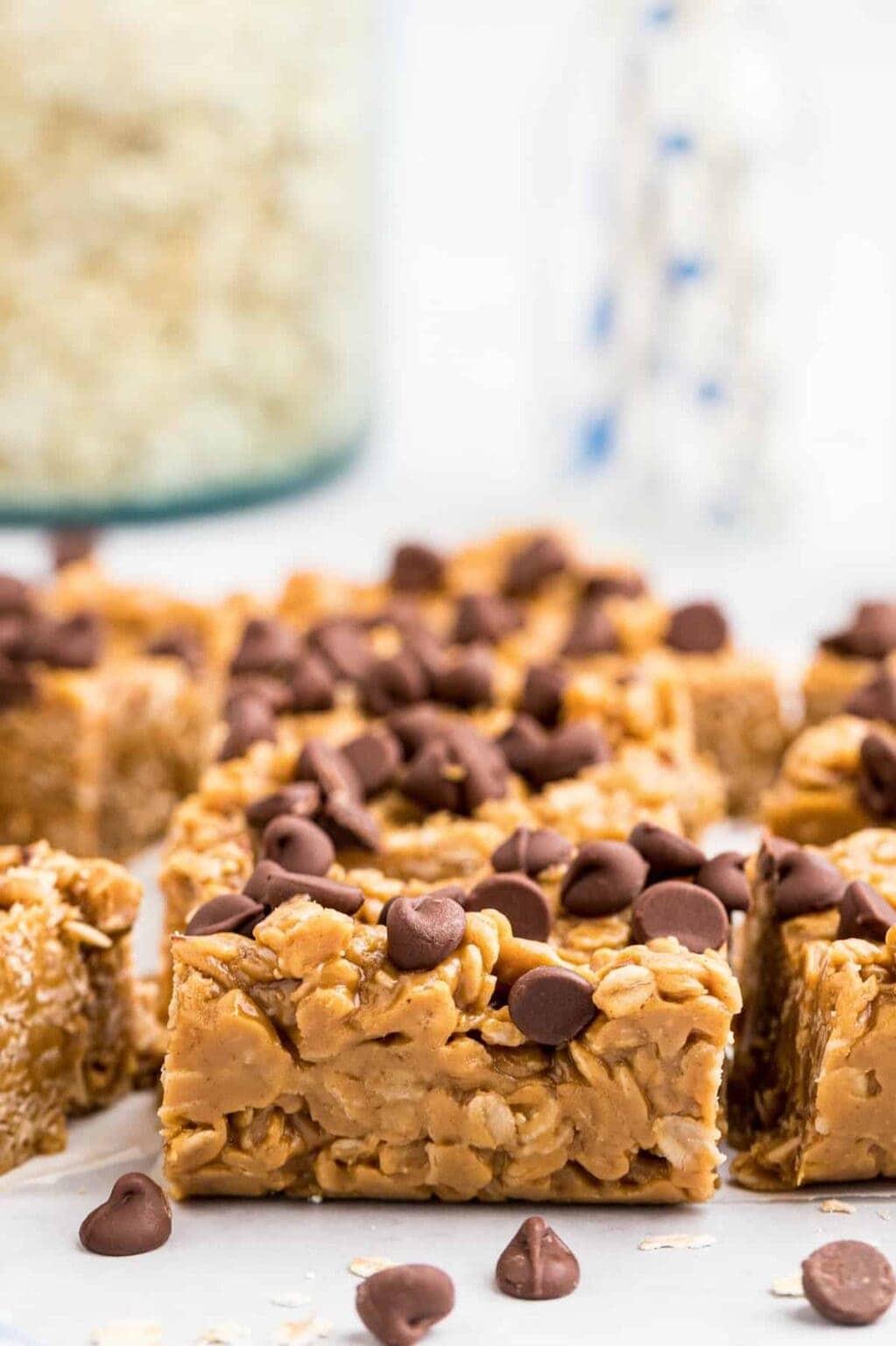 No-bake peanut butter oat bars topped with chocolate chips, cut into squares and arranged on a serving plate.